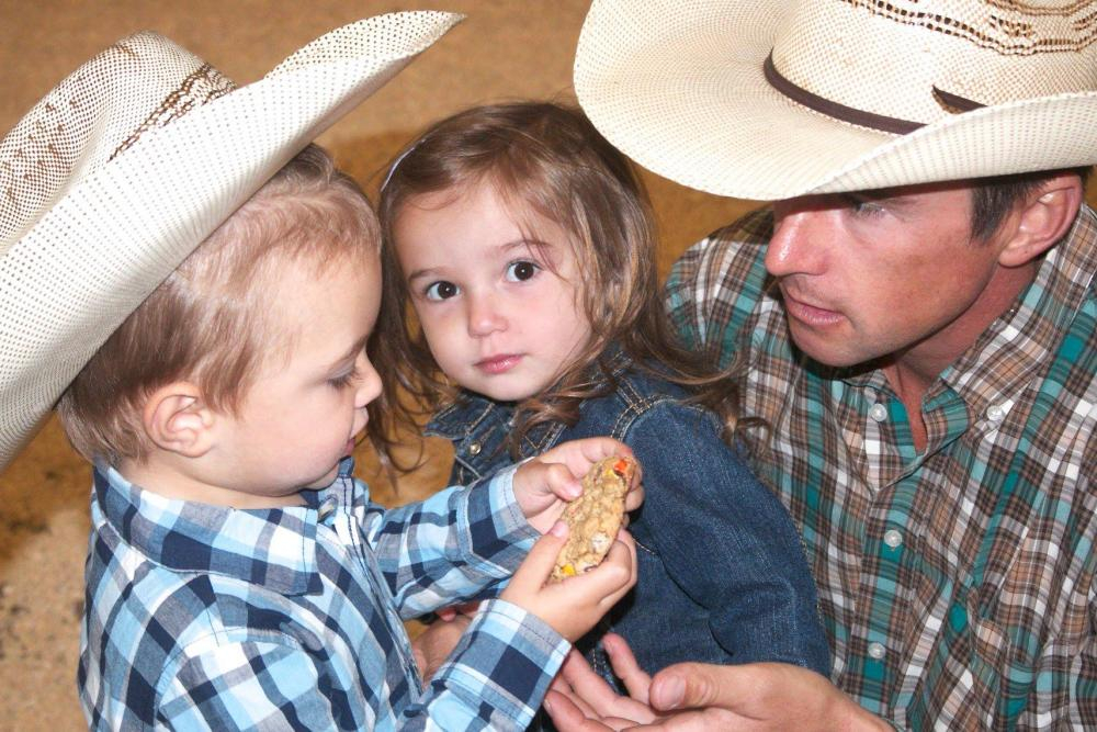 cute kids eating cookie at fair